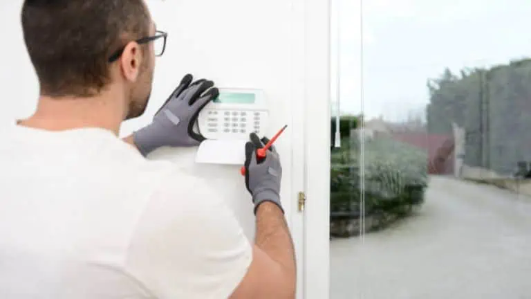 worker installing alarm technology insurance in home for burglar prevention Wirecom